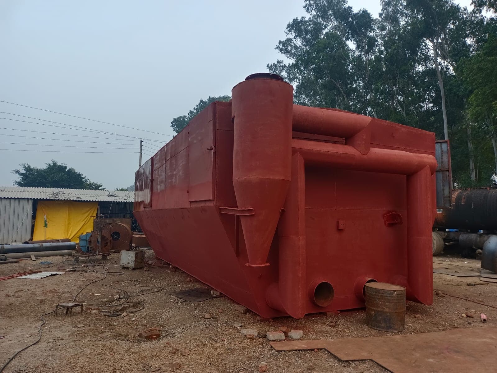 Heavy steel plate being rolled into a cylindrical shell section