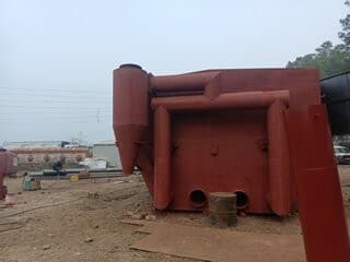Heavy steel plate being rolled into a cylindrical shell section